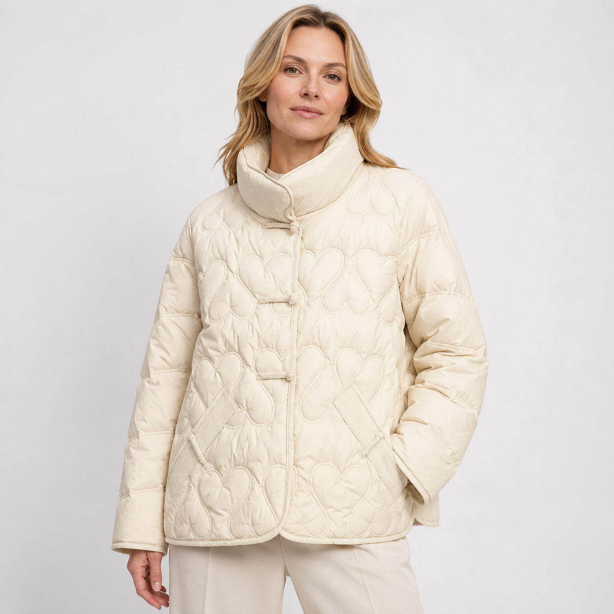 Woman wearing a ivory women's textured-quilt puffer jacket in a clean studio upper-body front view