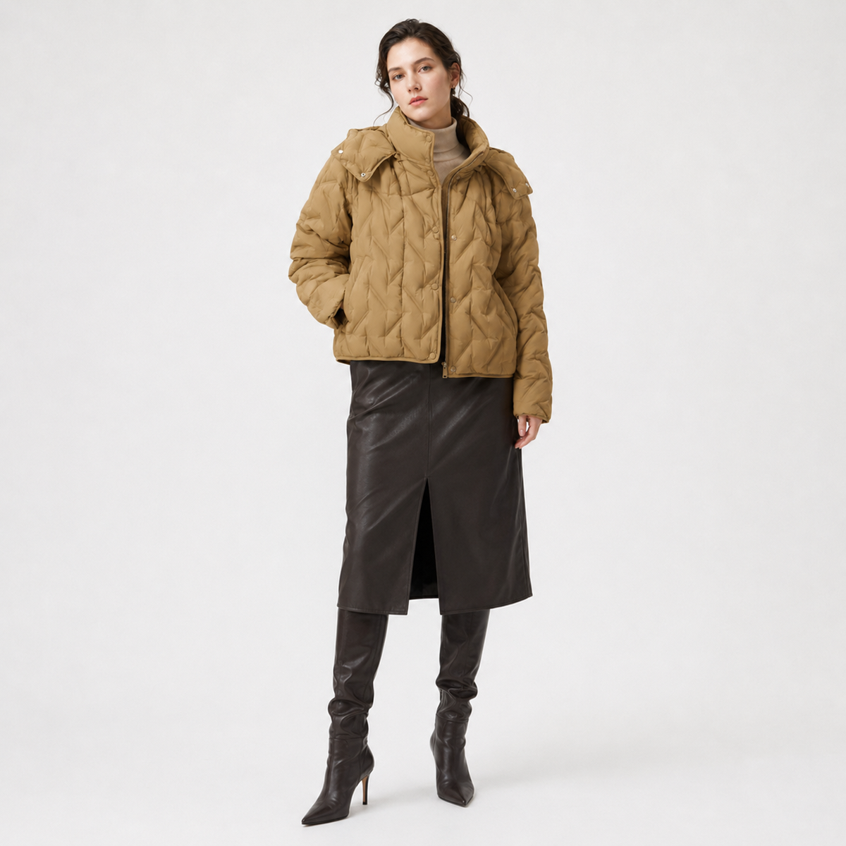 Model wearing a camel women's hooded puffer jacket in a clean full-body studio view