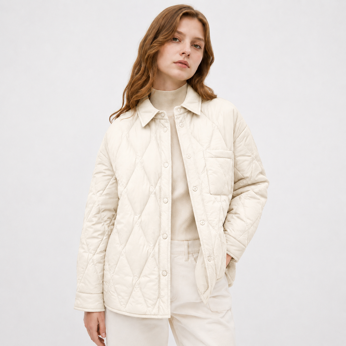 Model wearing a ivory women's diamond-quilted shirt jacket in a clean upper-body studio front view