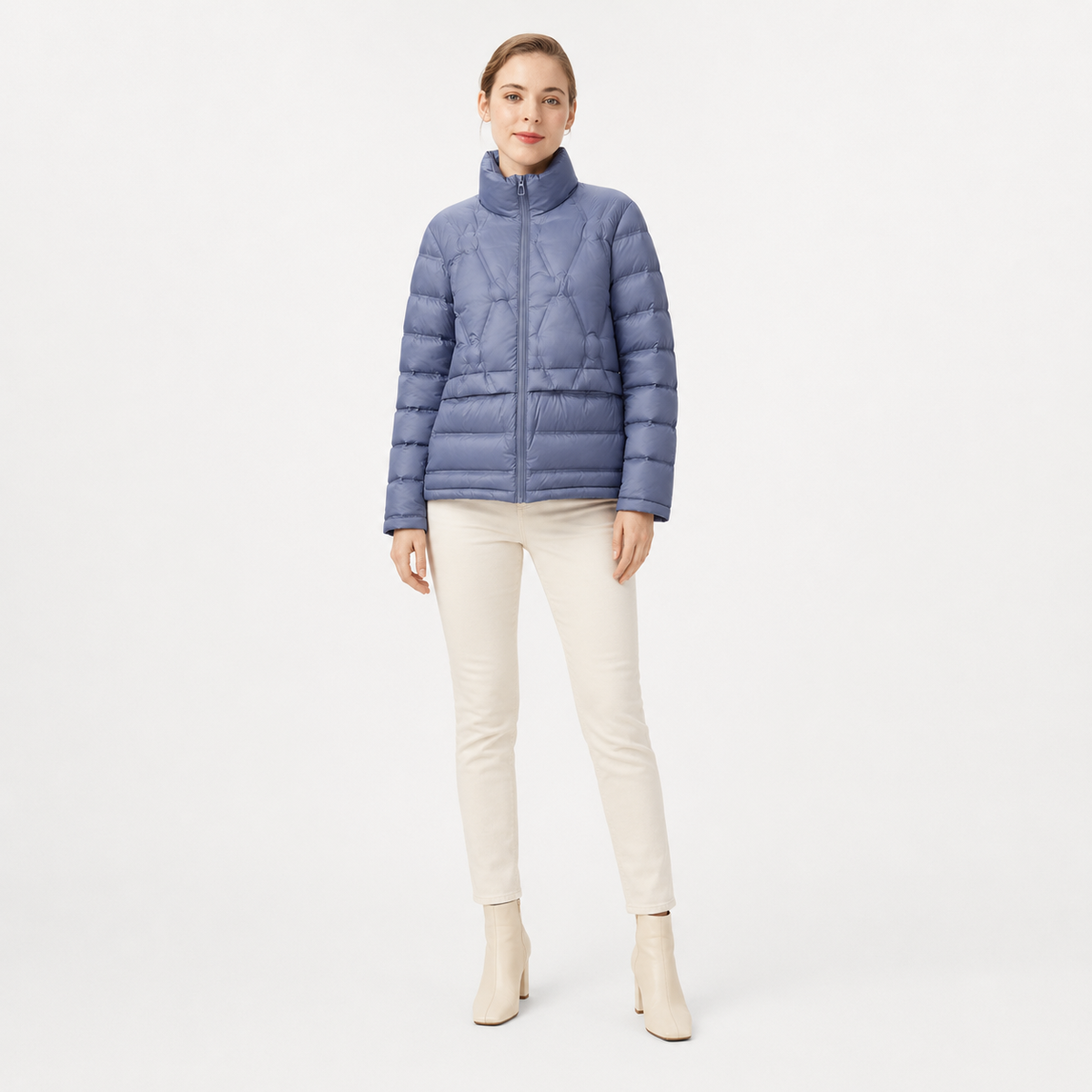 Model wearing a blue women's short puffer jacket in a clean full-body studio view