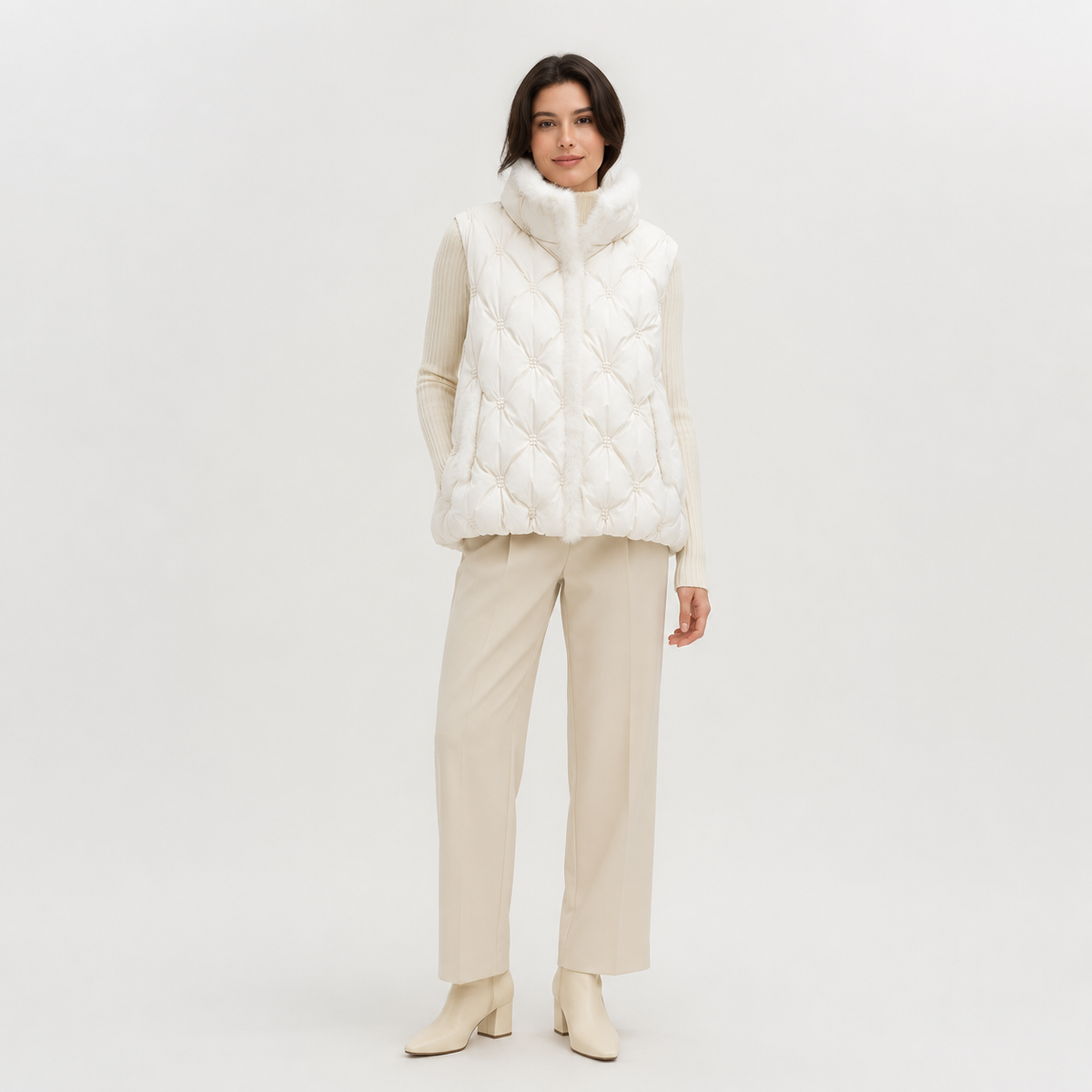 Model wearing a ivory women's hooded quilted puffer vest in a clean full-body studio view