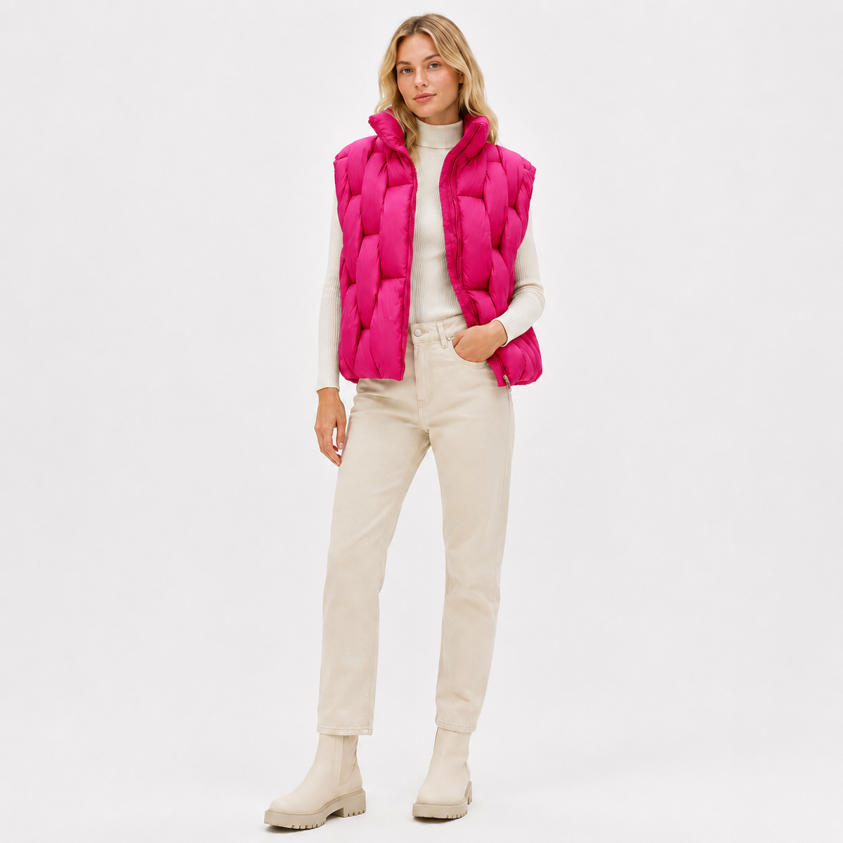 Model wearing a hot pink women's short puffer vest in a clean full-body studio view