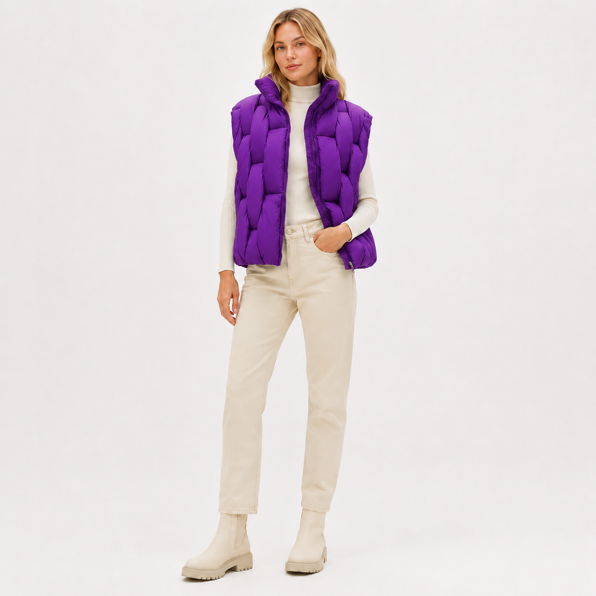 Model wearing a purple women's short puffer vest in a clean full-body studio view